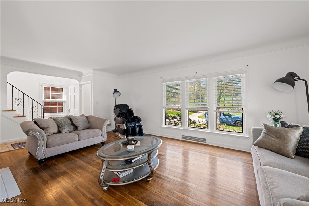 2471 Channing Road Cleveland, OH 44118 - Photo 7 of 33 Living area featuring baseboards, stairs, wood finished floors
