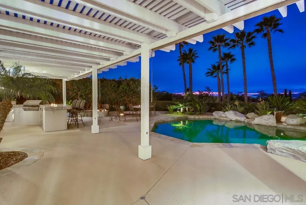 16157 Country Day Road Poway, CA 92064 - Photo 24 of 70 a view of a patio with a table and chairs under an umbrella