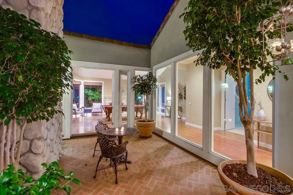 16157 Country Day Road Poway, CA 92064 - Photo 26 of 70 a view of a porch with chairs and potted plants