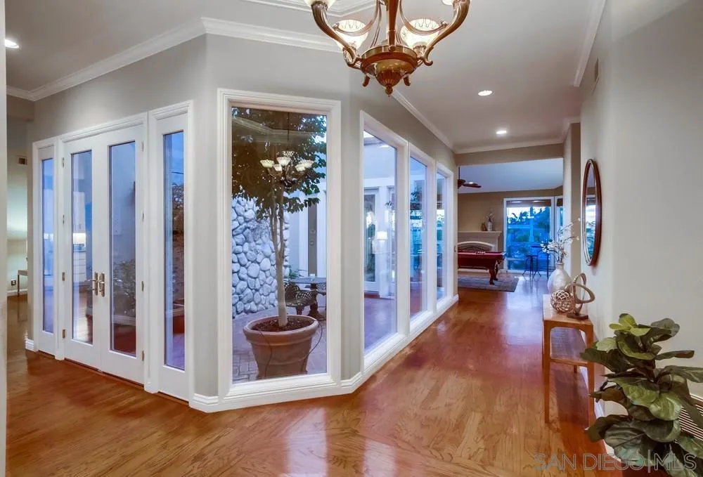 16157 Country Day Road Poway, CA 92064 - Photo 27 of 70 a view of a hallway with dining room and wooden floor