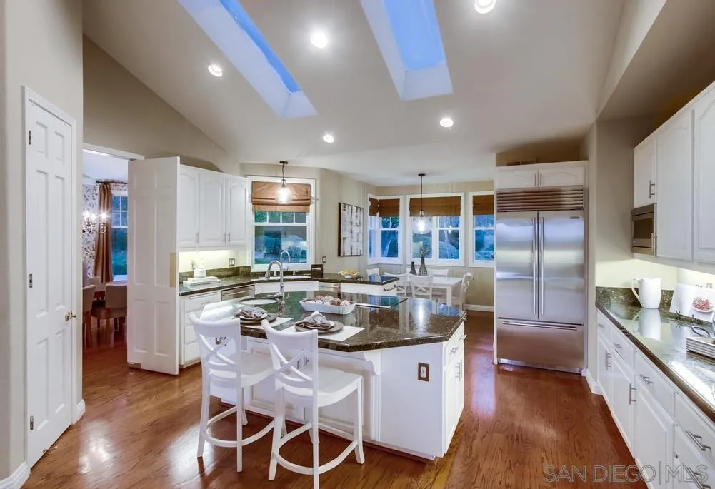 16157 Country Day Road Poway, CA 92064 - Photo 35 of 70 a kitchen with stainless steel appliances granite countertop a stove a sink a refrigerator and chairs