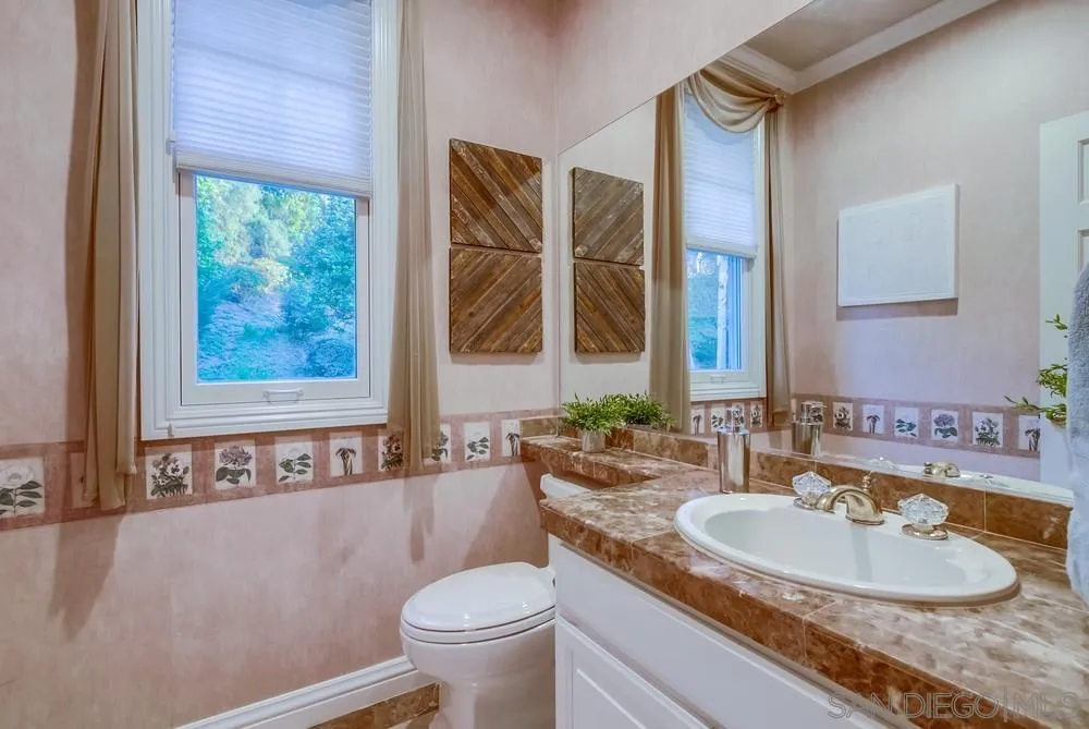 16157 Country Day Road Poway, CA 92064 - Photo 42 of 70 a bathroom with a granite countertop sink and a mirror