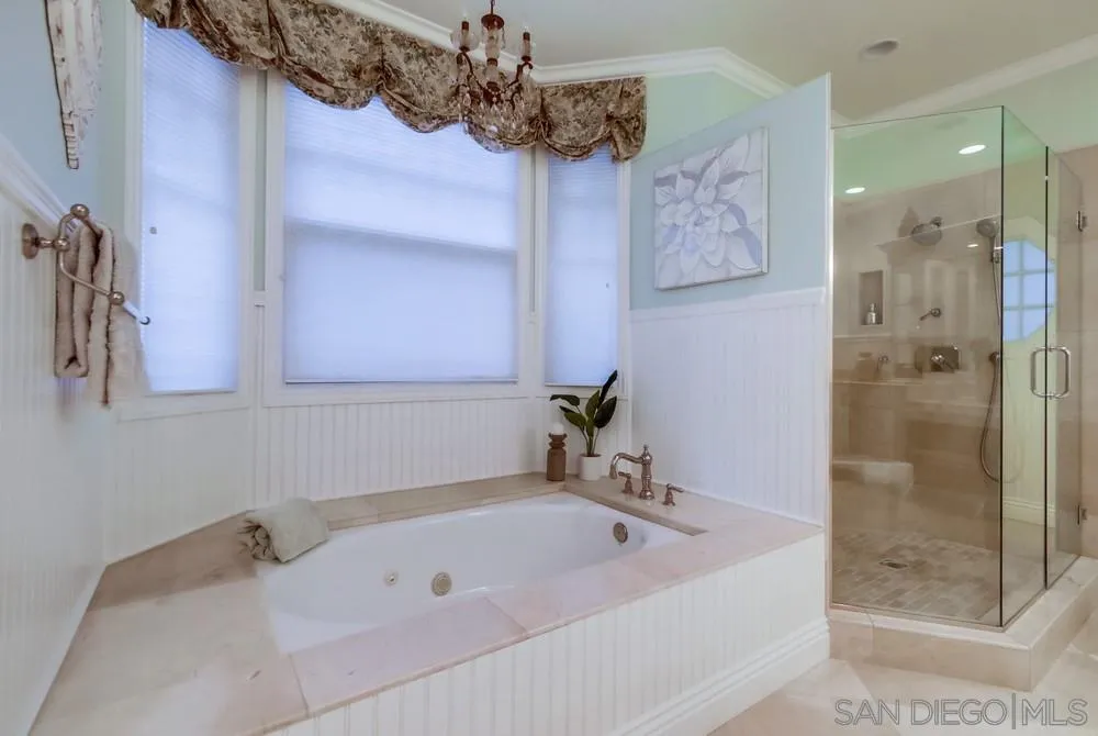 16157 Country Day Road Poway, CA 92064 - Photo 49 of 70 a bathroom with a tub a sink and glass door