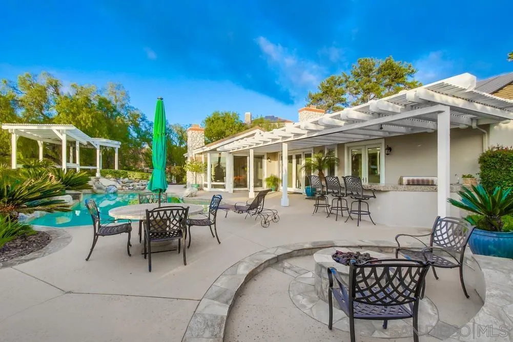 16157 Country Day Road Poway, CA 92064 - Photo 56 of 70 a view of a patio with table and chairs potted plants and a large tree