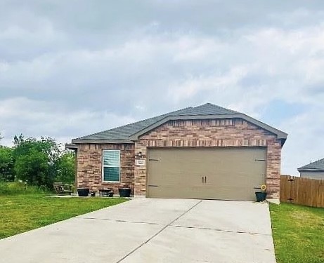 521 Locksley Cove Jarrell, TX 76537 - Photo 2 of 9 front view of a house with a garden