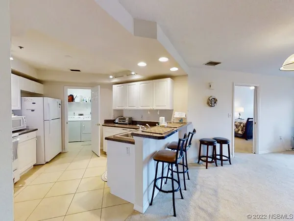 a kitchen with stainless steel appliances kitchen island granite countertop a sink and cabinets