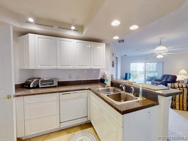 a kitchen that has a sink and cabinets