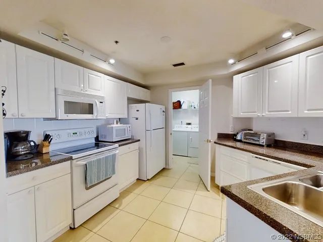 a kitchen with stainless steel appliances granite countertop a sink and cabinets