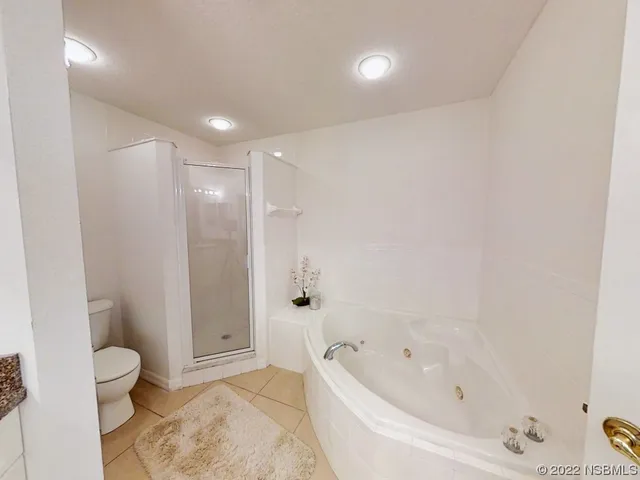 a bathroom with a bathtub and toilet