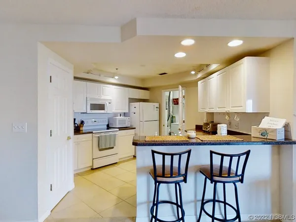 a kitchen that has a table and chairs in it