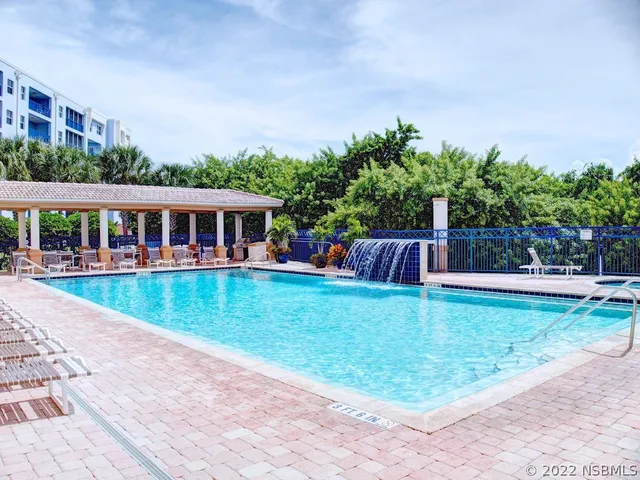 a view of a house with wooden deck and a yard