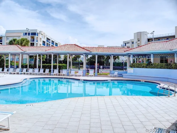 a view of house with swimming pool and porch