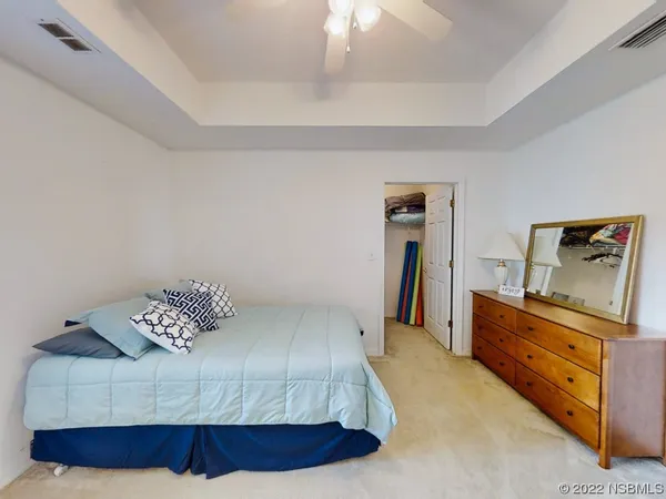 a bedroom with a bed and dresser