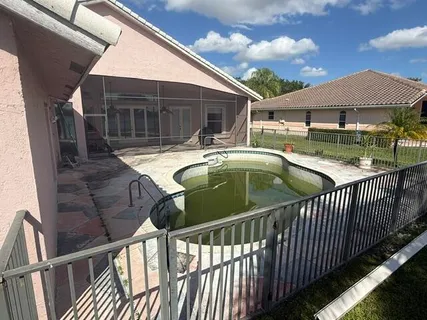 a view of a house with backyard and deck