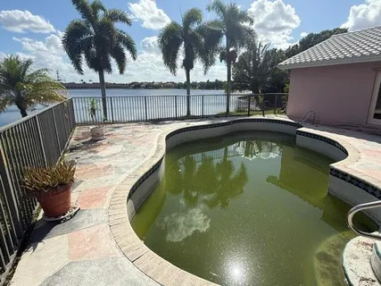 a view of a swimming pool with a patio