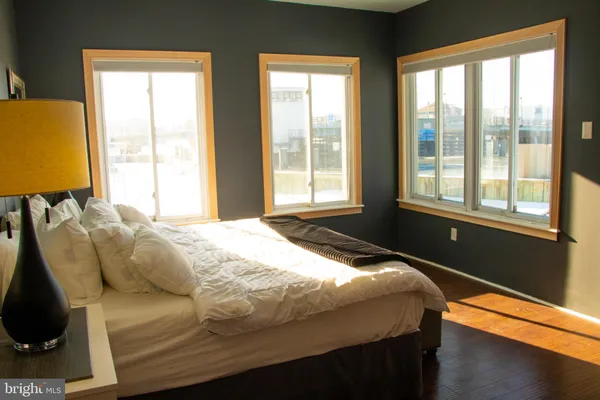 a bedroom with a bed and a lamp