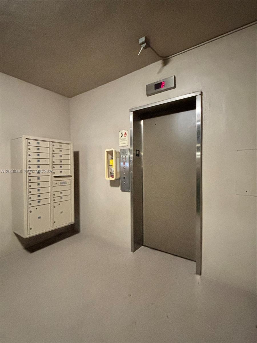 1480 East Sample Road, Unit 209 Pompano Beach, FL 33064 - Photo 4 of 24 a view of an empty room with wooden floor