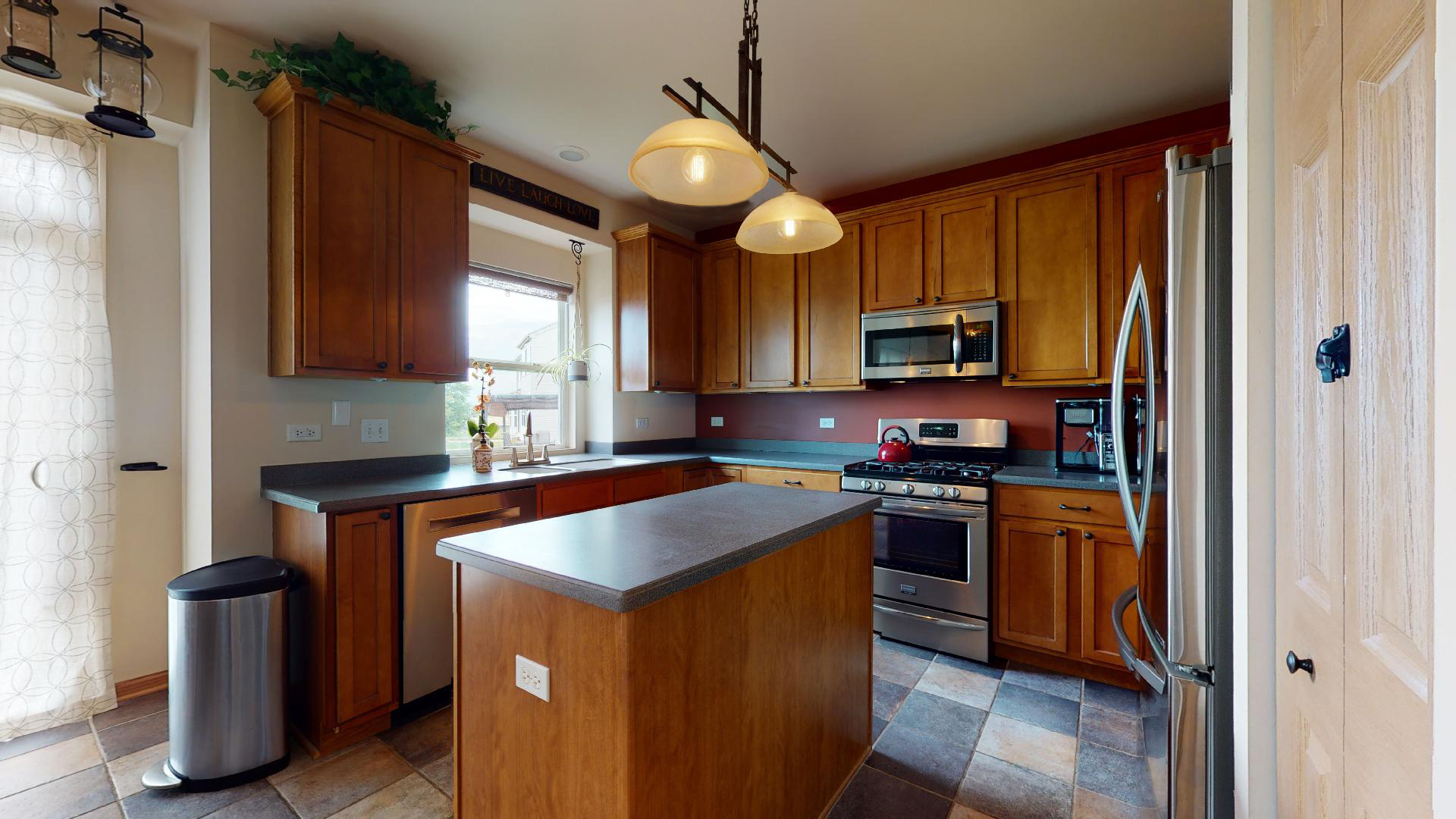 1637 Trails End Lane Bolingbrook, IL 60490 - Photo 16 of 40 a kitchen with stainless steel appliances granite countertop wooden cabinets a stove a sink and a refrigerator