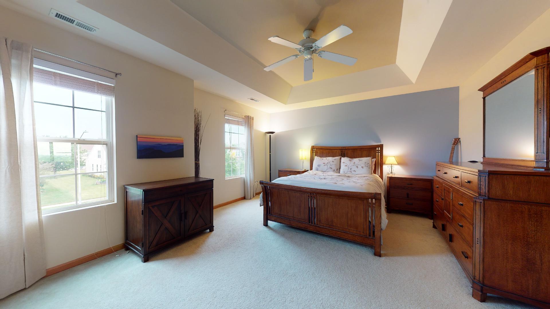 1637 Trails End Lane Bolingbrook, IL 60490 - Photo 32 of 40 a spacious bedroom with a bed flat screen tv and windows
