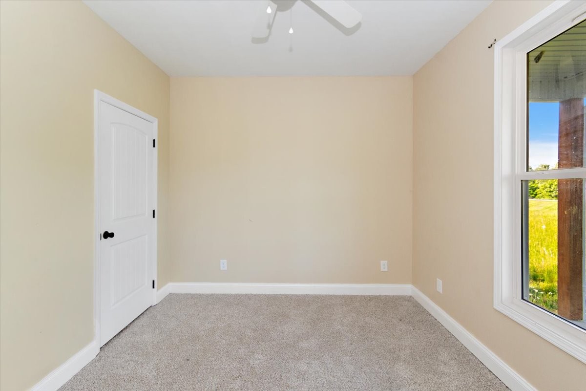 118 East Biggs Road Portland, TN 37148 - Photo 11 of 26 an empty room with windows and a ceiling fan