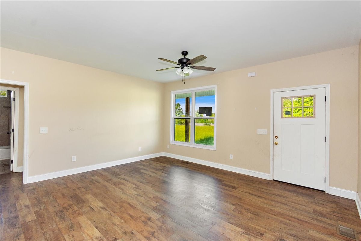 118 East Biggs Road Portland, TN 37148 - Photo 6 of 26 an empty room with windows and chandelier fan