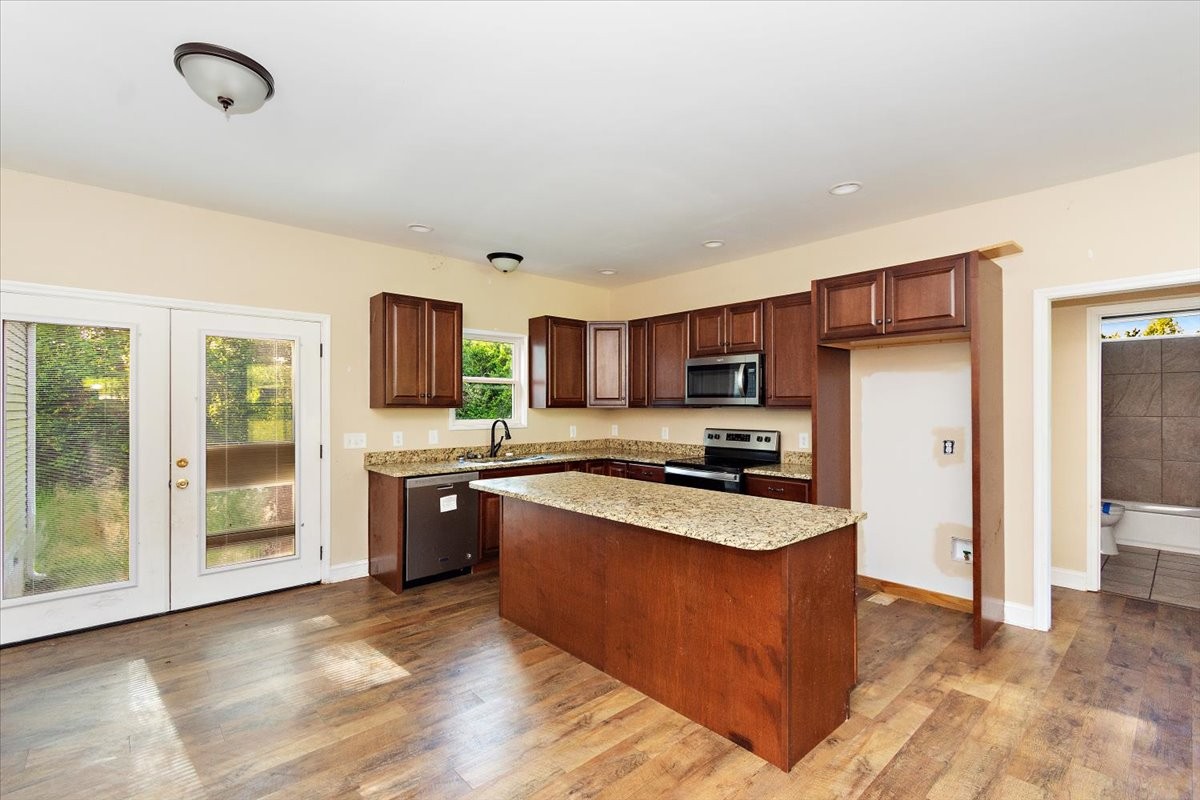 118 East Biggs Road Portland, TN 37148 - Photo 7 of 26 a kitchen with stainless steel appliances granite countertop a stove refrigerator and a sink