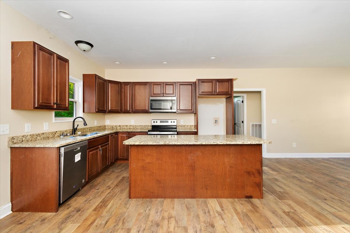 118 East Biggs Road Portland, TN 37148 - Photo 8 of 26 a large kitchen with wooden floors and stainless steel appliances