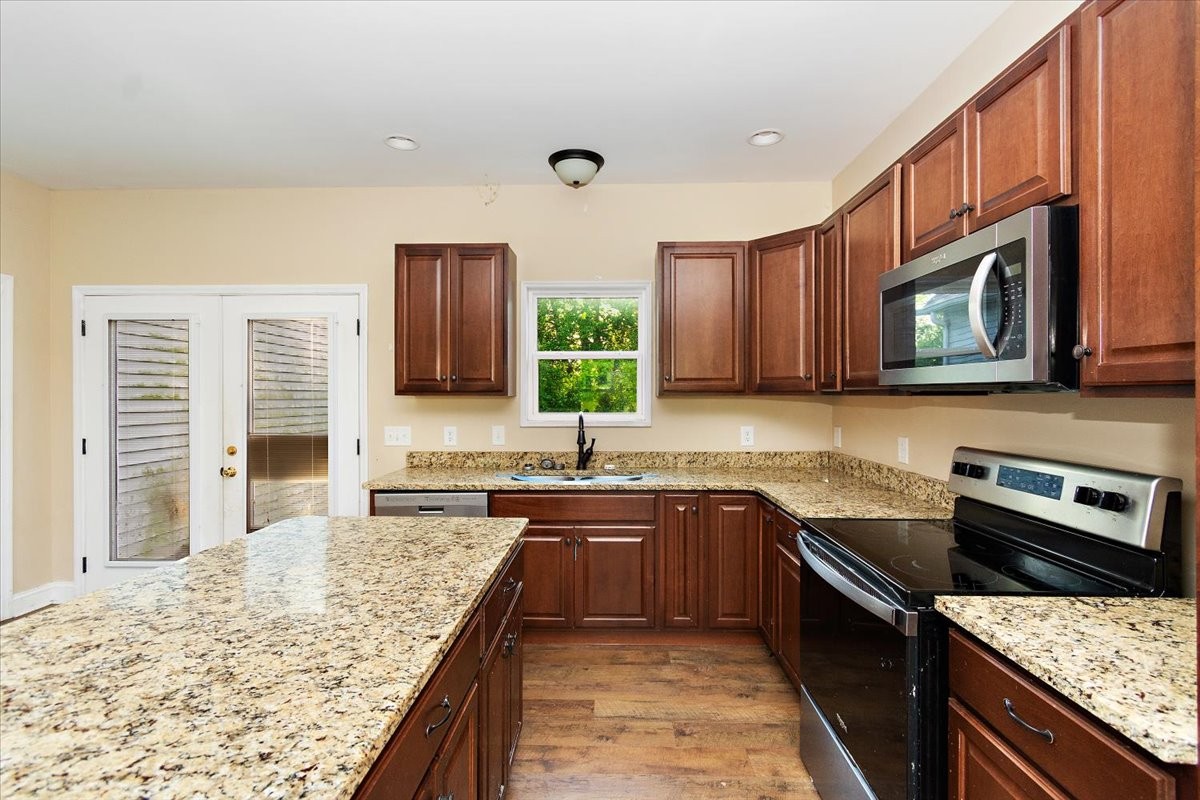 118 East Biggs Road Portland, TN 37148 - Photo 9 of 26 a kitchen with stainless steel appliances granite countertop a sink stove and microwave