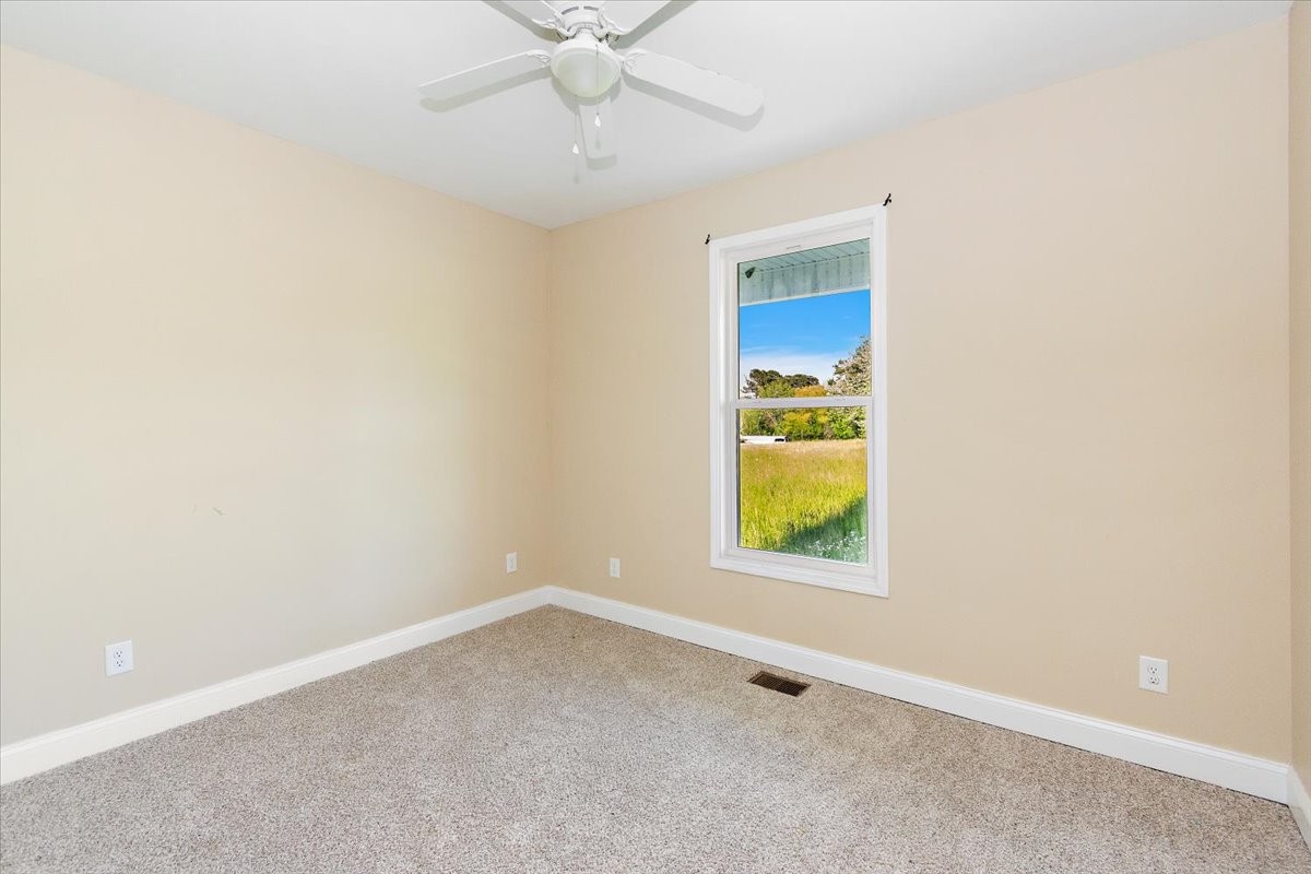 118 East Biggs Road Portland, TN 37148 - Photo 10 of 26 an empty room with a window and a chandelier fan