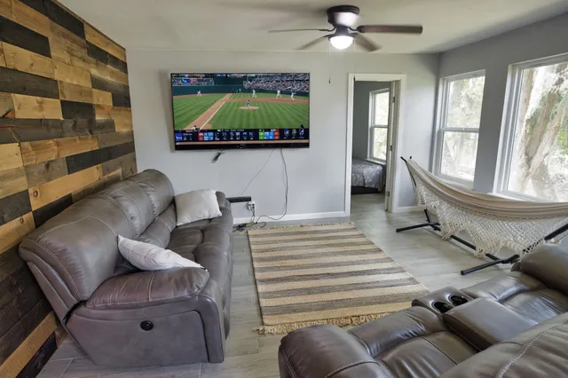 a living room with furniture and a flat screen tv