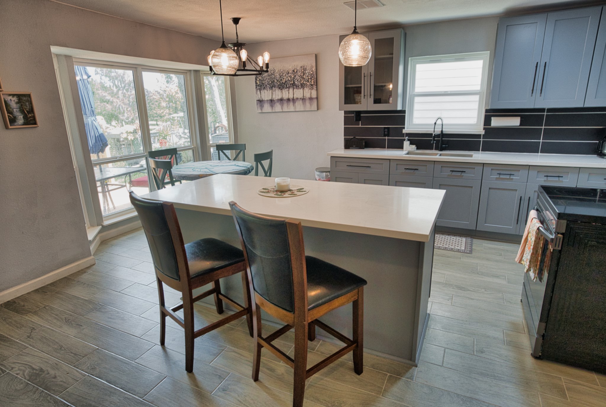 5401 County Road 334, Unit 10 Sweeny, TX 77480 - Photo 6 of 15 a kitchen with stainless steel appliances granite countertop a kitchen island hardwood floor sink stove dining table and chairs