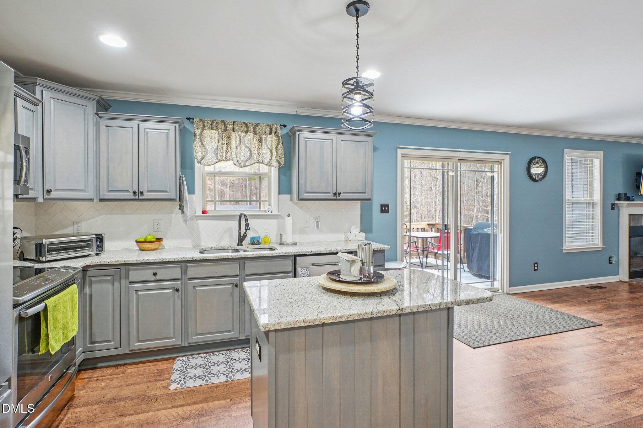 265 North Ridge Drive Louisburg, NC 27549 - Photo 13 of 33 a kitchen with sink cabinets and window