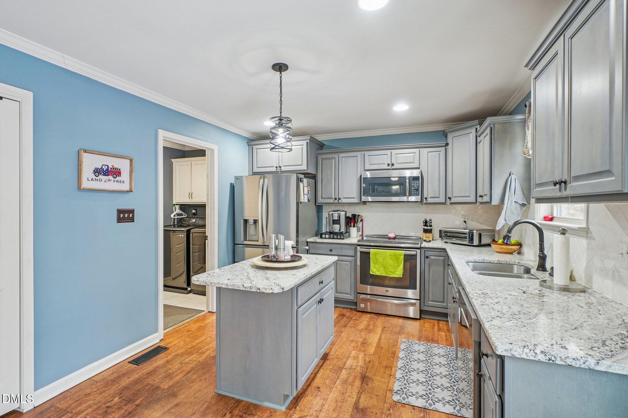 265 North Ridge Drive Louisburg, NC 27549 - Photo 15 of 33 a kitchen with sink refrigerator and microwave