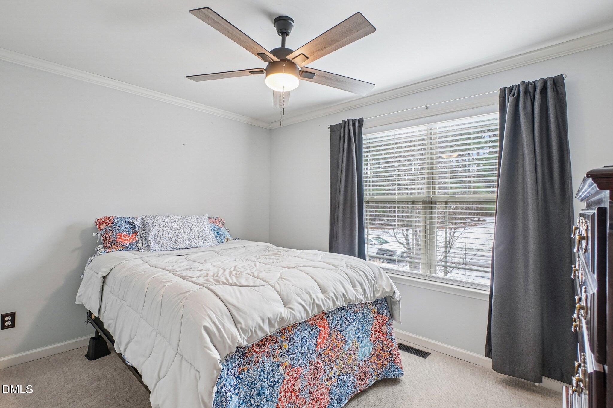 265 North Ridge Drive Louisburg, NC 27549 - Photo 27 of 33 a bedroom with a bed and a large window