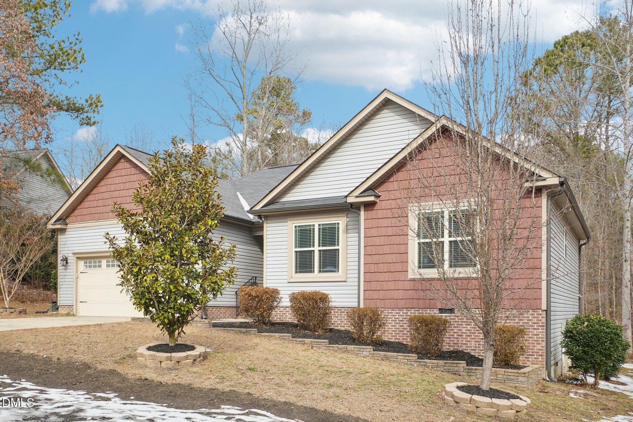 265 North Ridge Drive Louisburg, NC 27549 - Photo 3 of 33 a front view of a house with garden