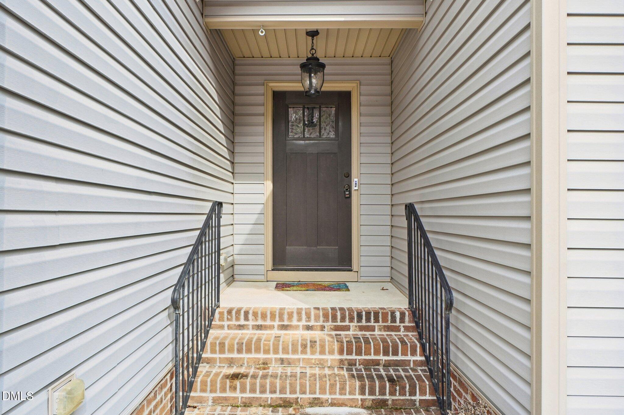 265 North Ridge Drive Louisburg, NC 27549 - Photo 4 of 33 a view of a brick house with windows