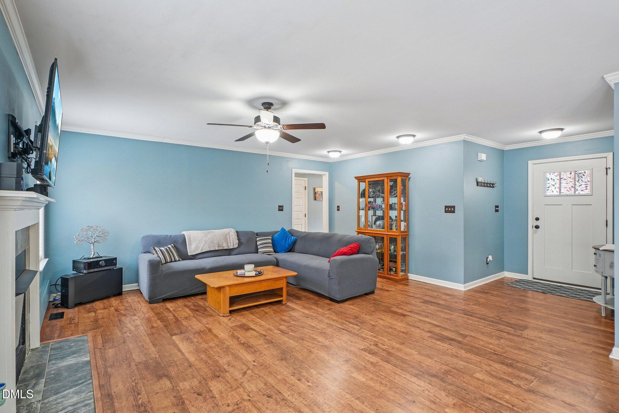 265 North Ridge Drive Louisburg, NC 27549 - Photo 6 of 33 a living room with furniture and a chandelier