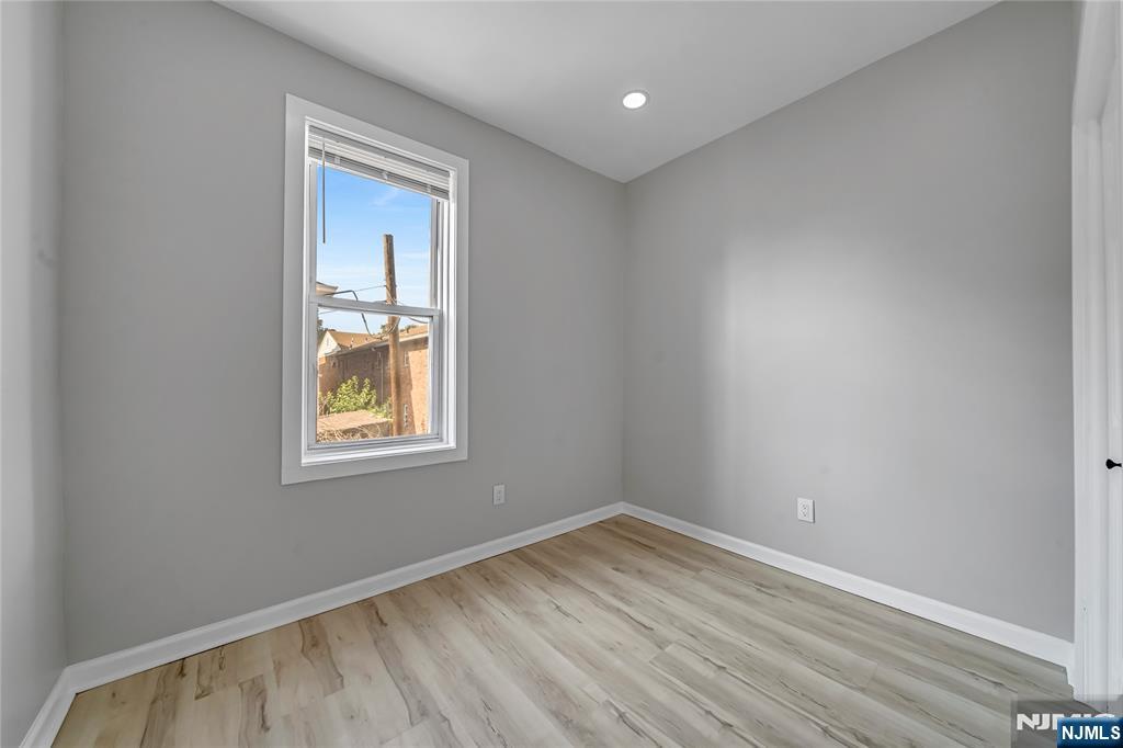 53 Henry Street, Unit D2 Passaic, NJ 07055 - Photo 5 of 12 wooden floor in an empty room