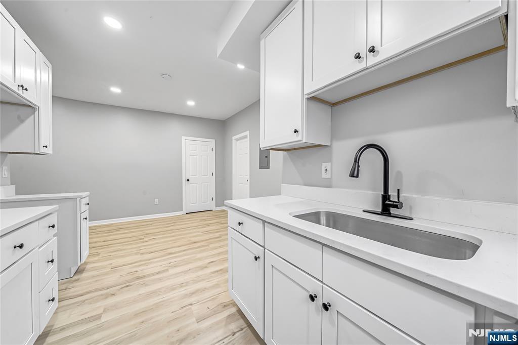 53 Henry Street, Unit D2 Passaic, NJ 07055 - Photo 7 of 12 a kitchen with a sink and cabinets