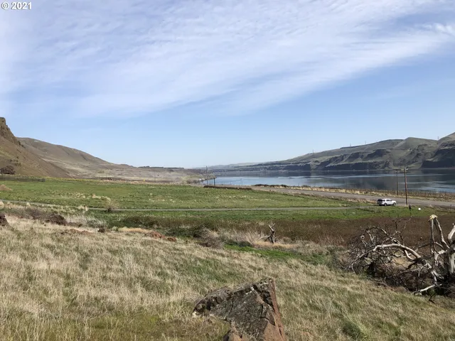 a view of mountain with sunset in background