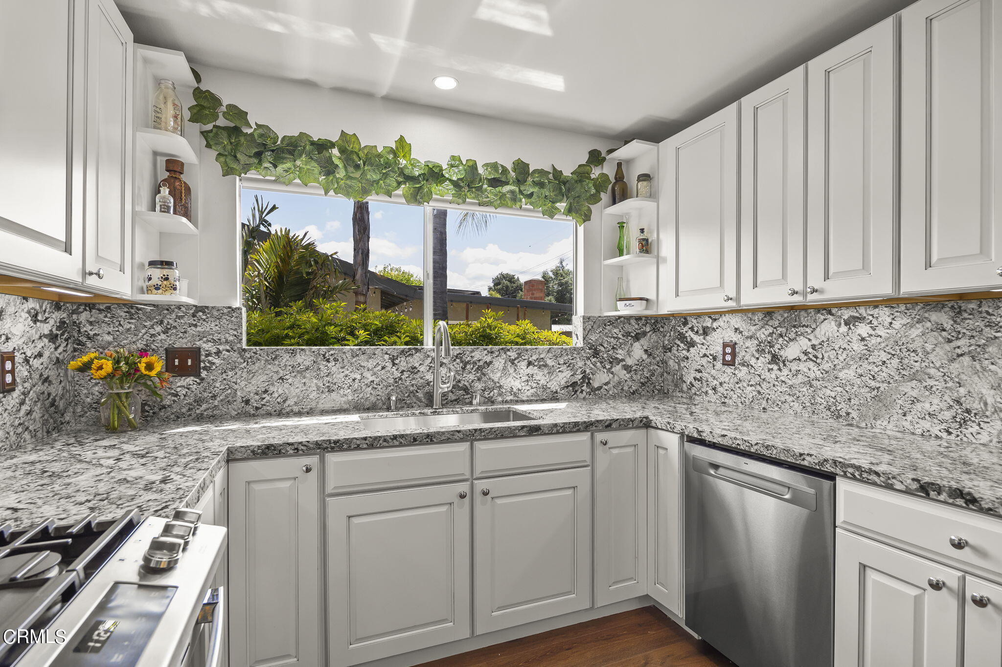 1162 Tico Road Ojai, CA 93023 - Photo 13 of 53 a kitchen with stainless steel appliances white cabinets and a granite counter tops