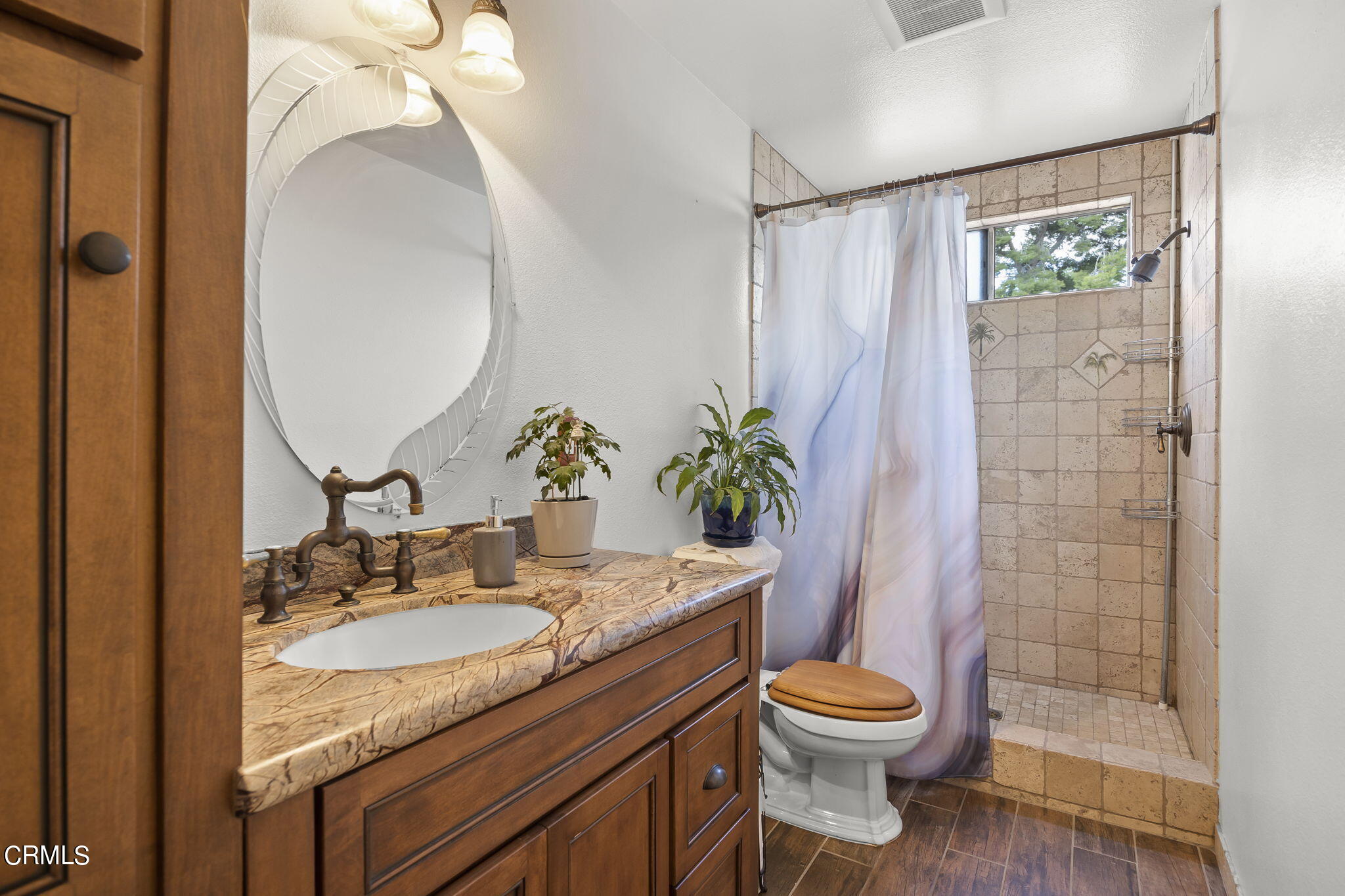 1162 Tico Road Ojai, CA 93023 - Photo 19 of 53 a bathroom with a granite countertop sink toilet a mirror and shower