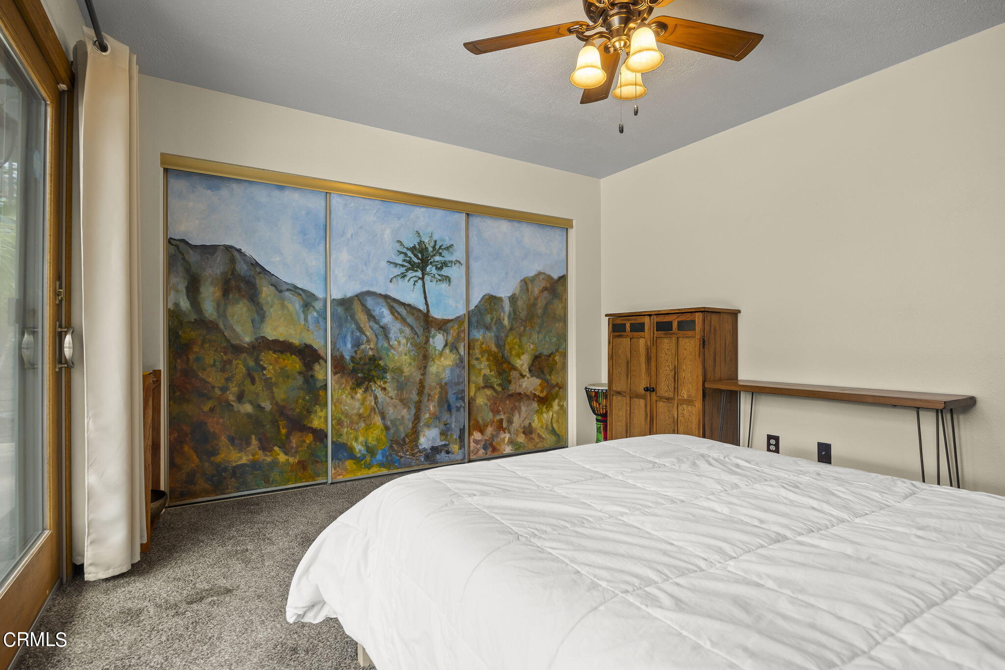 1162 Tico Road Ojai, CA 93023 - Photo 26 of 53 a bedroom with a large bed and a chandelier