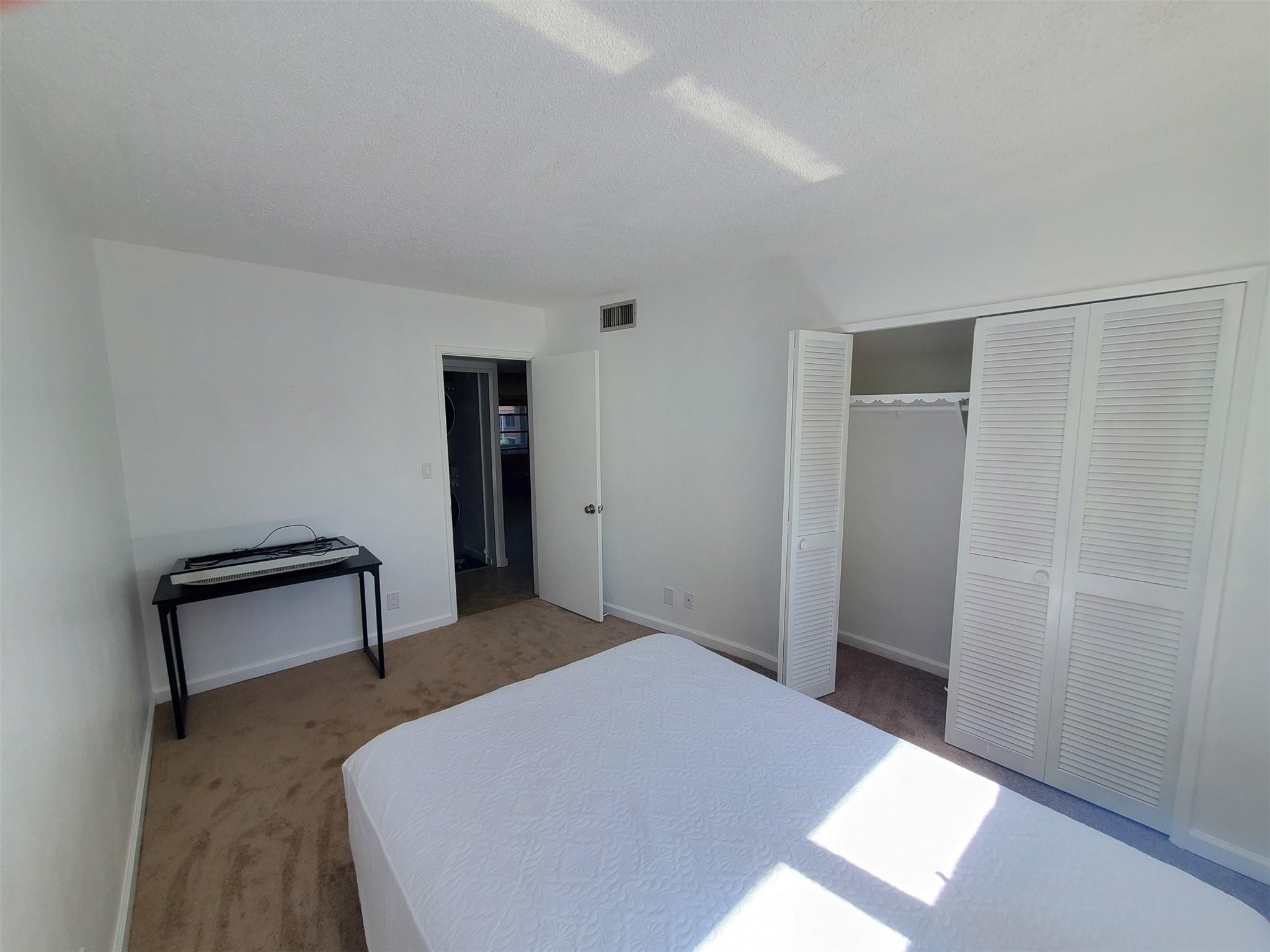 651 Pine Drive, Unit 305 Pompano Beach, FL 33060 - Photo 11 of 15 a bedroom with a bed and a desk