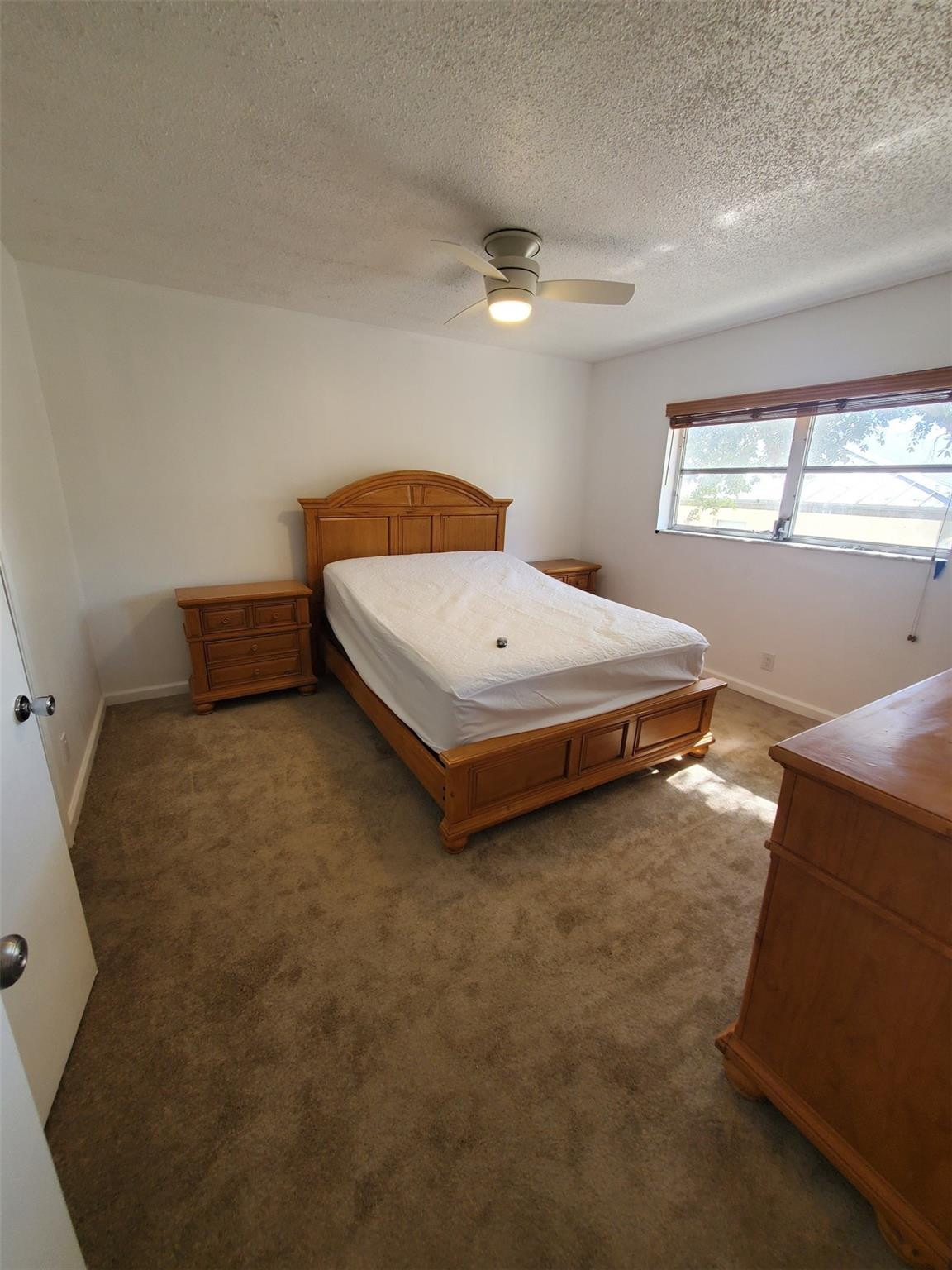 651 Pine Drive, Unit 305 Pompano Beach, FL 33060 - Photo 12 of 15 a bedroom with a bed and window