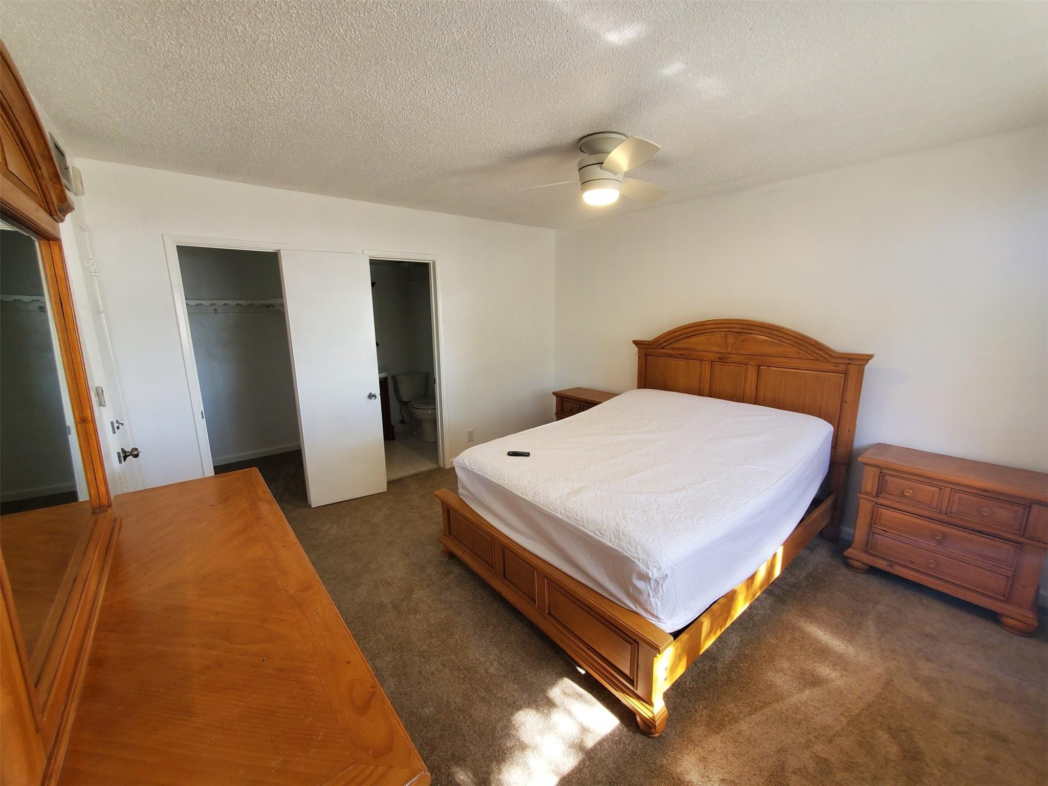 651 Pine Drive, Unit 305 Pompano Beach, FL 33060 - Photo 13 of 15 a bedroom with a bed and a dresser