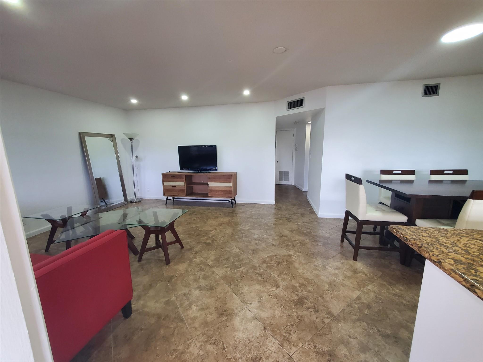 651 Pine Drive, Unit 305 Pompano Beach, FL 33060 - Photo 3 of 15 a living room with furniture and a flat screen tv