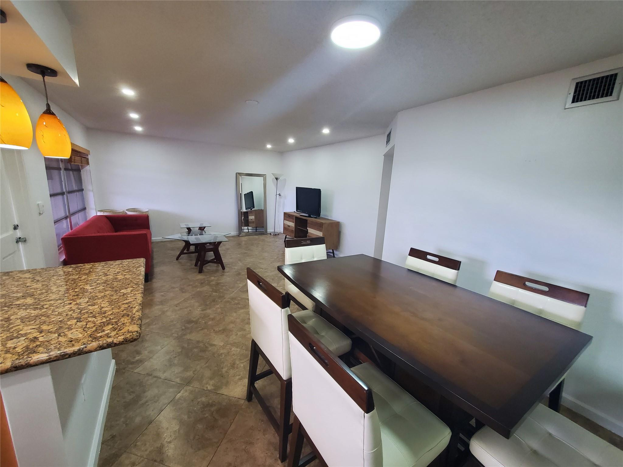 651 Pine Drive, Unit 305 Pompano Beach, FL 33060 - Photo 6 of 15 a living room with furniture