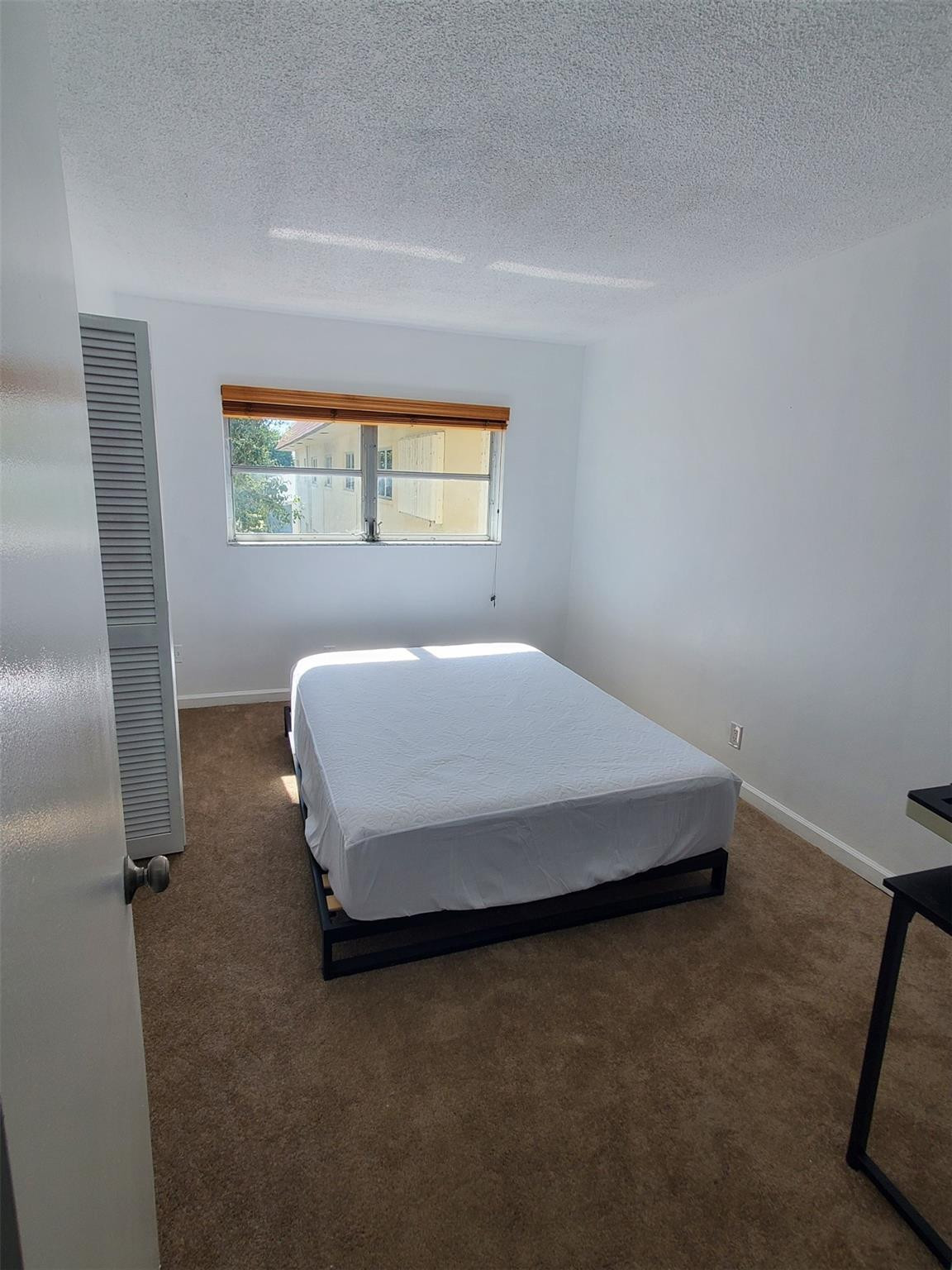 651 Pine Drive, Unit 305 Pompano Beach, FL 33060 - Photo 10 of 15 a bedroom with a bed and window