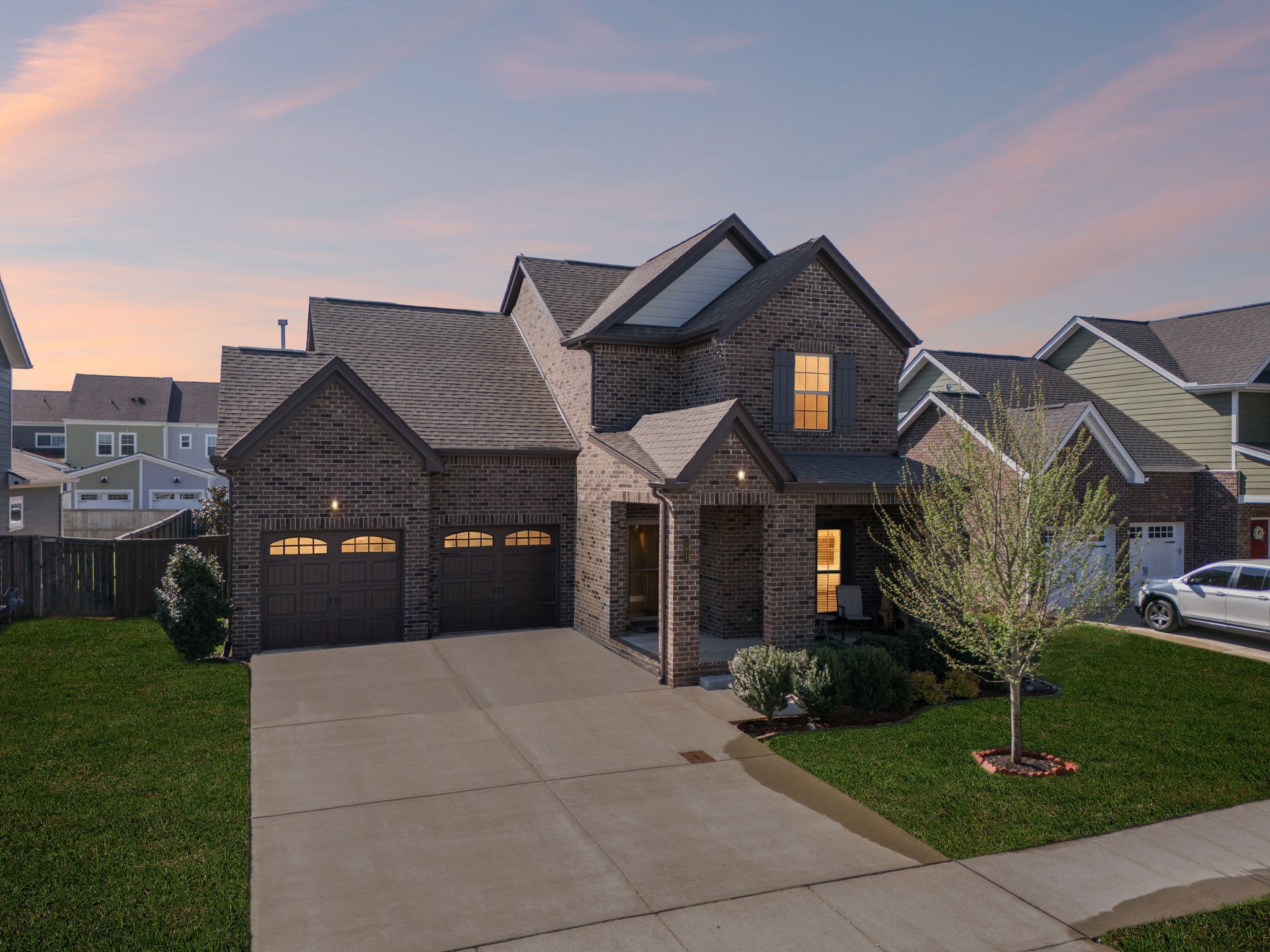 a front view of a house with a yard and garage